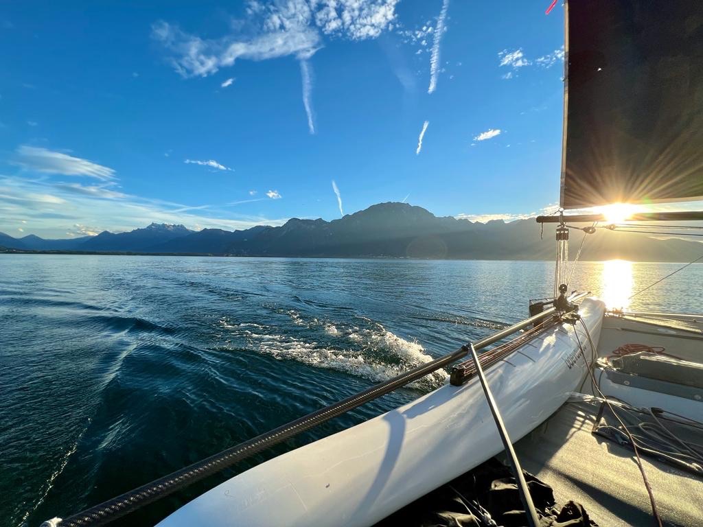 Golden light over Lake Geneva from a private sailing boat